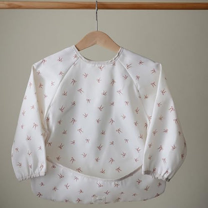 mushie Long Sleeve Baby Bib | Water Resistant Adjustable Fit - color: Bows
